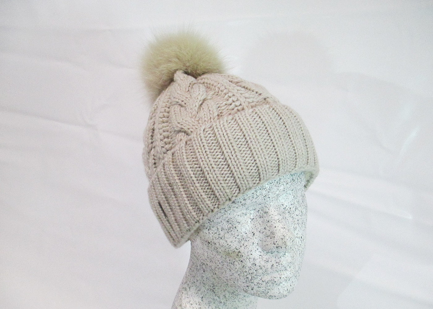 Braided cap with fox pompom