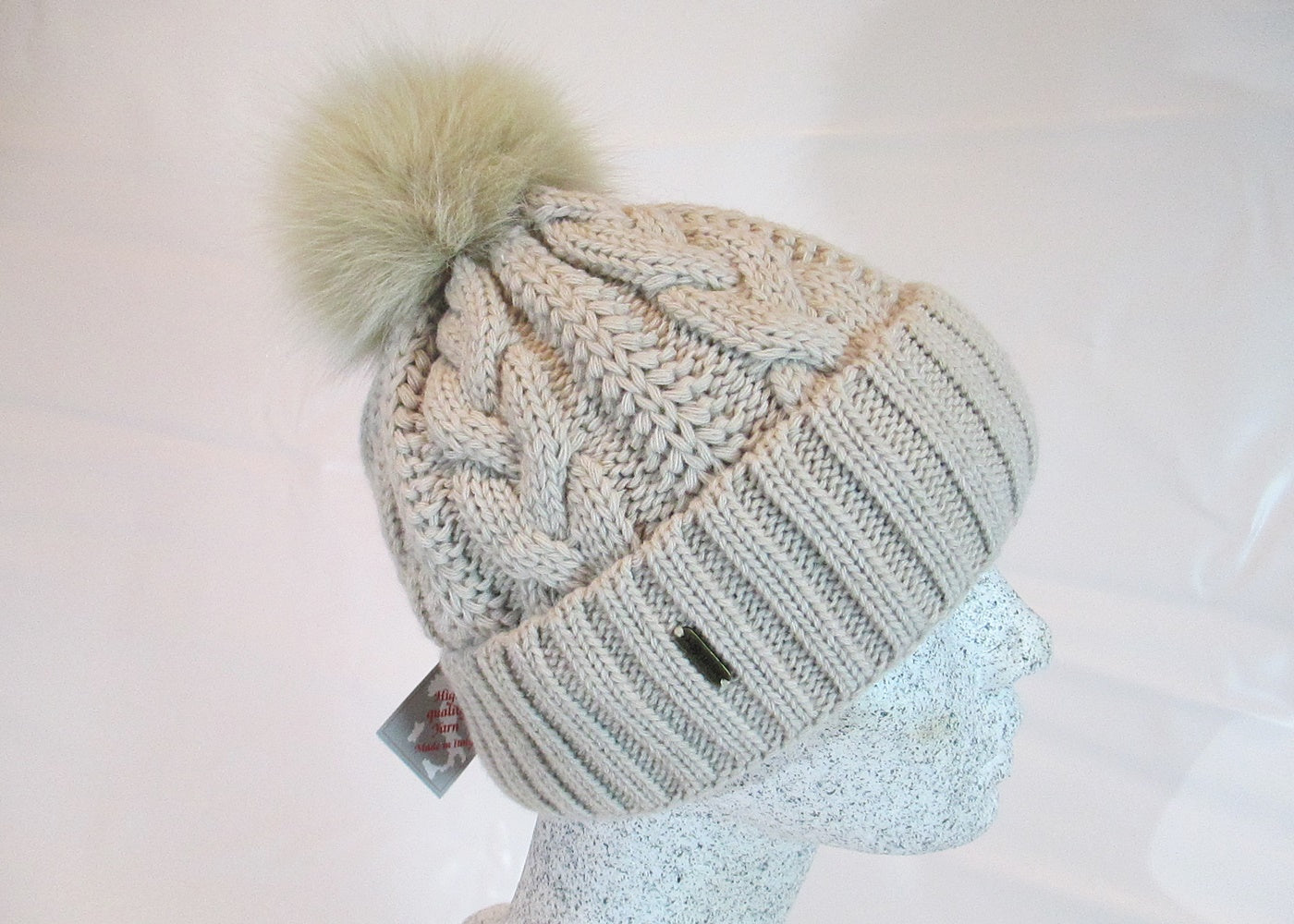 Braided cap with fox pompom