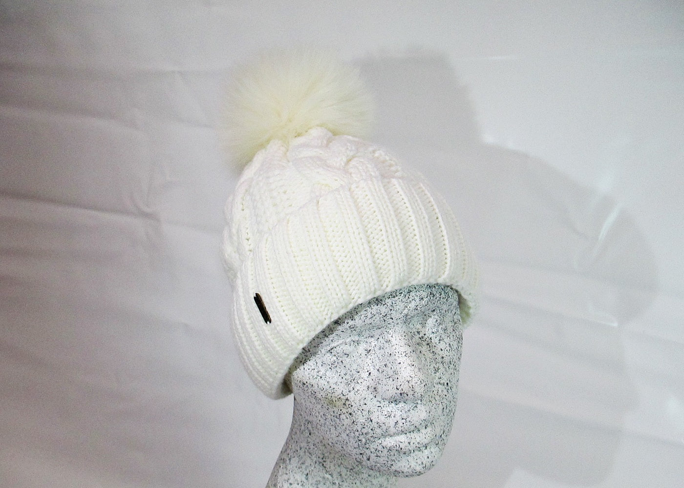 Braided cap with fox pompom