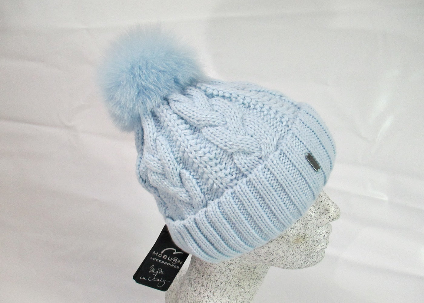 Braided cap with fox pompom