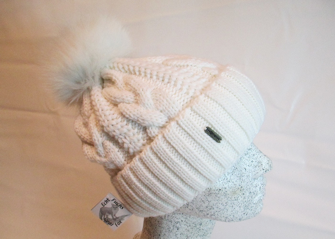 Braided cap with fox pompom