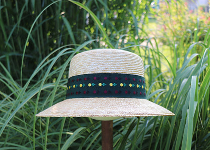 Braided straw hat with a colorful ribbon