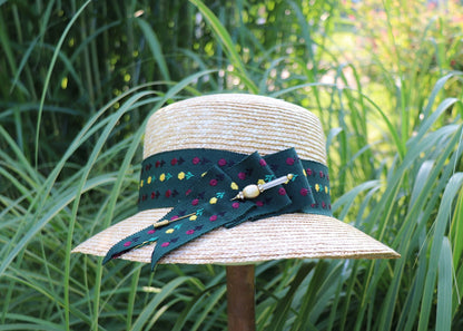 Braided straw hat with a colorful ribbon